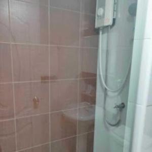a bathroom with a shower with a toilet in it at THOUSAND-TEN THOUSAND HOTEL in Sathani Wat Sing +7 photos
