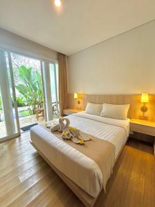 Postel nebo postele na pokoji v ubytování The Hita Apartement