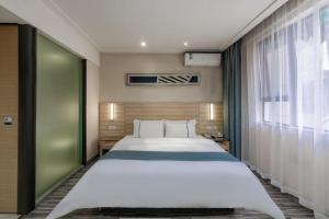 Ένα ή περισσότερα κρεβάτια σε δωμάτιο στο City Comfort Inn Wuhan Zongguan Metro Station +197 φωτογραφίες