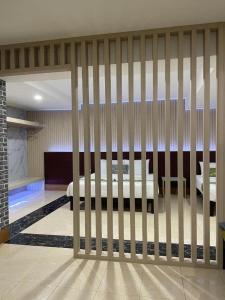 a room with a fence with a bed in it at Saysamphanh Hotel in Ban Nongkham