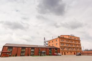 a building in front of a cloudy sky at Monte Carlo Reghin in Reghin