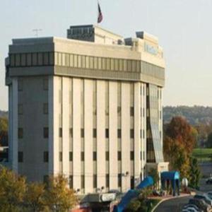 a large white building with a flag on top of it at Valley Forge Casino Resort in King of Prussia