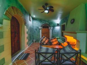 Una sala de estar con un sofá y un ventilador de techo. en Villa Tuscany Country Resort, en Ratchaburi