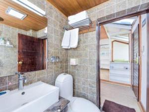 une salle de bain avec toilettes, lavabo et miroir dans l'établissement Dali Four Seasons Hostel, à Vieille ville de Dali 274 autres photos