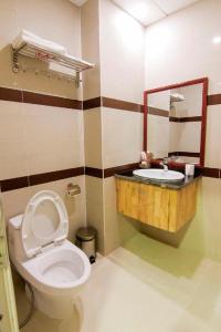 a bathroom with a toilet and a sink at TVT Hotel in Da Lat