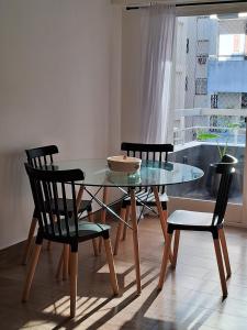 La PorteñaRecoleta, departamento de lujo a estrenar的配有玻璃桌椅的餐厅