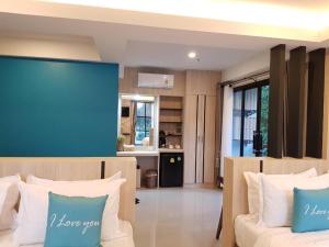 a living room with two beds and a kitchen at SEESEA RESORT in Amphoe Langu