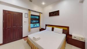 a bedroom with a bed and a window and a door at Lucky Mother Bungalow in Chaweng