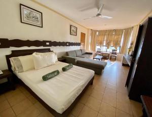 a bedroom with a large bed and a living room at Lago de Oro in Batangas City +110 photos