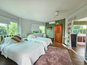 two beds in a room with green walls at Baan Chiang Residence & Resort- Hua Hin in Ban Pak Ngam +73 photos