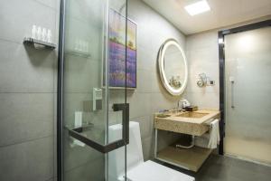 a bathroom with a shower and a sink at Lavande Hotels Heze Changjiang Road Wanda Plaza in Zhaolou +22 photos