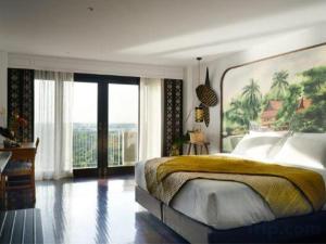 a bedroom with a large bed and a large window at RXV Wellness Village in Nakhon Pathom