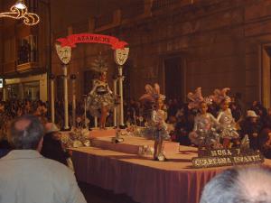 a group of people standing around a table with figurines on it at Los Geraneos in Águilas