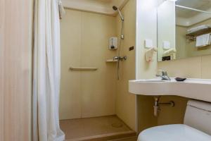 a bathroom with a shower and a sink and a toilet at Jinjiang Inn Taiyuan Longtan Park in Taiyuan +138 photos