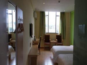 a hotel room with two beds and a television at 7 Days Inn Bijie Jinsha Hebin Road in Jinsha +116 photos