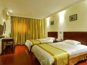 a hotel room with two beds and a window at GreenTree Inn Nanjing Software Valley DaDingFang Express Hotel in Nanjing +139 photos