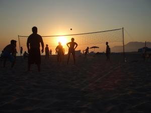 a group of people playing a game of volleyball on the beach at Dardanos Hotel in Patara