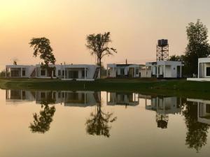 a group of houses next to a body of water at I View Park Resort in Udon Thani