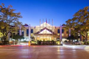 a building at night with a parking lot in front at Expo Garden Hotel in Kunming