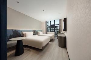 Postel nebo postele na pokoji v ubytování Light Hotel Hangzhou West Lake Yintai Nansong Royal Street