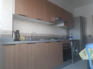a kitchen with a sink and a dishwasher at Chez Fatima - Nassim Gh12 in Mohammedia