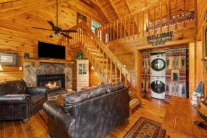 a living room with leather furniture and a fireplace at Cherry Lake Hideaway in Blue Ridge