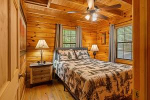 a bedroom with a bed and a ceiling fan at Cherry Lake Hideaway in Blue Ridge
