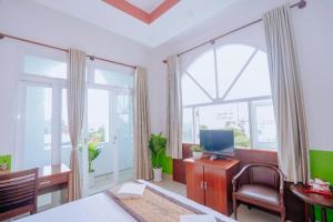 a bedroom with a bed and a desk with a computer at Hotel 175 Saigon in Ho Chi Minh City +63 photos