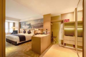 a hotel room with a bed and a desk at Sky World Hotel Qingdao in Qingdao +271 photos