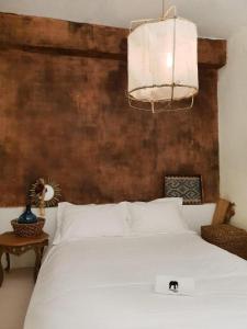 a bedroom with a white bed and a chandelier at Hotel Elephant in Busan