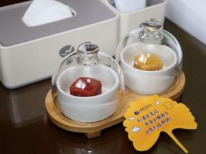 two glass containers filled with different types of food at Liwan International Hotel Chengdu in Chengdu
