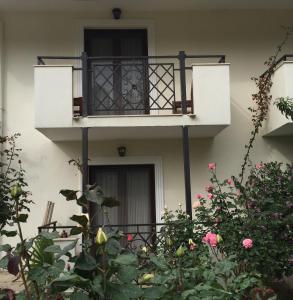 a building with a balcony and some flowers at Dardanos Hotel in Patara