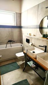 A bathroom at Vass Villa Vendégház és Pincészet Felsőörs Még 32 kép