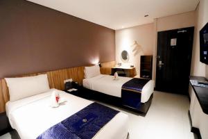 Кровать или кровати в номере Fitra Hotel Majalengka +71 фотография