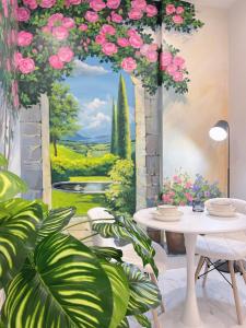 a painting of a room with a table and flowers at Relax Homestay 6 in Kon Rung (1)
