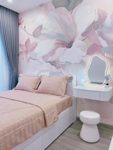 a bedroom with a bed with a flower mural at Relax Homestay 6 in Kon Rung (1)