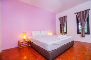 une chambre avec un grand lit et deux fenêtres dans l'établissement Baan Chuengkao Resort, à Ranong 158 autres photos