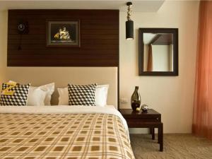a bedroom with a large bed and a mirror at Rashmi's Plaza Hotel Vientiane in Vientiane +84 photos