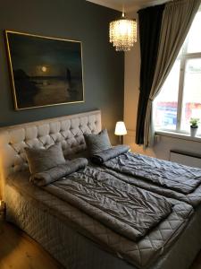 a bedroom with a large bed with pillows on it at Ebbas vandrarhem in Borgholm