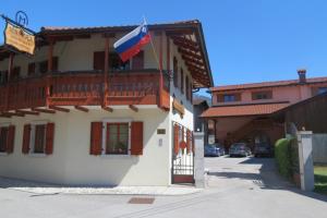 a flag on a balcony of a building at Apartments Masera in Kobarid