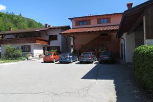 a group of cars parked in a parking lot at Apartments Masera in Kobarid