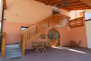 a staircase in a room with a table and chairs at Apartments Masera in Kobarid