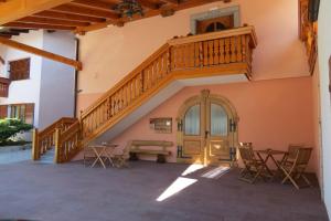a staircase in a building with chairs and a table at Apartments Masera in Kobarid