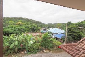 a view of a garden from a house at OYO 75351 Na Jinthanakan in Ban Tha Lo