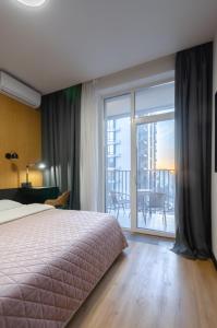 Un ou plusieurs lits dans un hébergement de l'établissement Petrovdom Apartments 6-107 in RC Yaroslaviv Grad, Bulvarno-Kudriavska 17b