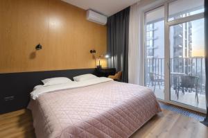 Un ou plusieurs lits dans un hébergement de l'établissement Petrovdom Apartments 6-107 in RC Yaroslaviv Grad, Bulvarno-Kudriavska 17b