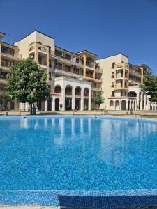 a large swimming pool in front of a building at Apartment with balcony, Lighthouse Golf Resort, 62sqm in Balchik