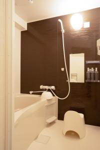 a bathroom with a white toilet and a sink at AsashiobashiBase in Osaka +35 photos