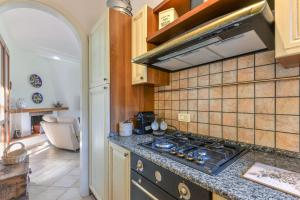a kitchen with a stove and a counter top at Villino Martini in Marciana +20 photos
