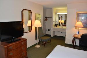 a hotel room with a television and a bedroom at Chicago Lake Shore Hotel in Chicago